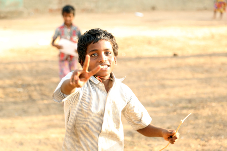 NANNILAM, INDIA - 11 MAY 2016: Close up portrait of a boy running towards cameraのeditorial素材
