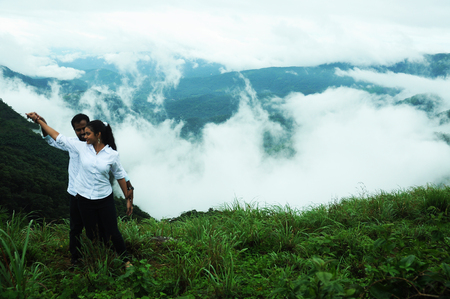 KODAIKANAL, INDIA - 30 JUNE, 2015: Hugging couple in high mountains, couple hugging in beautiful mountainsのeditorial素材