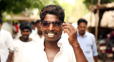 NANNILAM, INDIA - 19 MAY 2016: Portrait of a handsome young man in sunglasses on posing outdoorsのeditorial素材