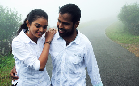 KODAIKANAL, INDIA - JUNE 30TH, 2015: happy young loving couple having fun outdoor in summertimeのeditorial素材