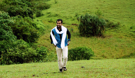 OOTY, INDIA - 30 JUNE, 2015: young man walking alone the outdoorsのeditorial素材