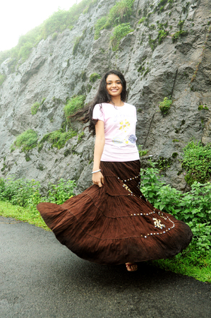 OOTY, INDIA - 30 JUNE, 2015: A happy woman walking on a path on a mountainのeditorial素材