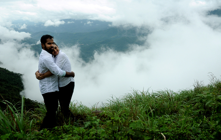 KODAIKANAL, INDIA - 30 JUNE, 2015: Hugging couple in high mountains, couple hugging in beautiful mountains (4)のeditorial素材