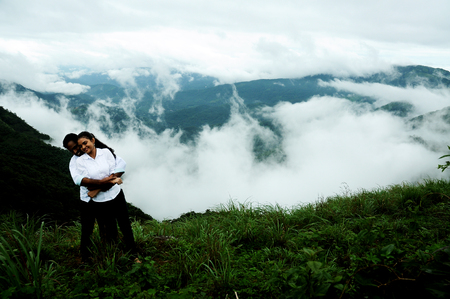 KODAIKANAL, INDIA - JUNE 30TH, 2015: Hugging couple in high mountains, couple hugging in beautiful mountainsのeditorial素材