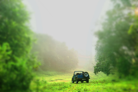 Close up blue old Jeep car parking on the India.man jumping outside at carのeditorial素材