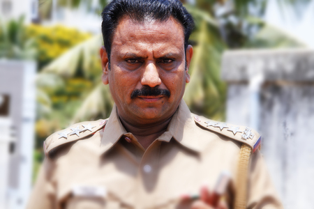 Indian police officer looking at camera closeupのeditorial素材