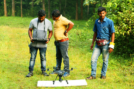 KODAIKANAL, INDIA - JUNE 21, 2016: Young man with two assisted photographer is shooting video with...