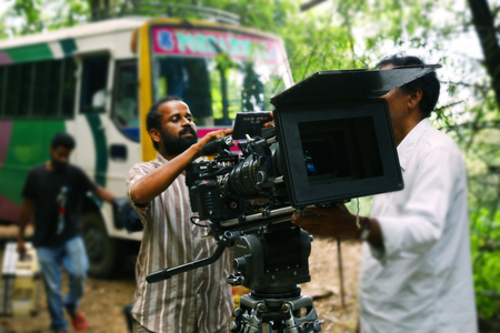 Video camera operator on nature background, film shooting spotのeditorial素材