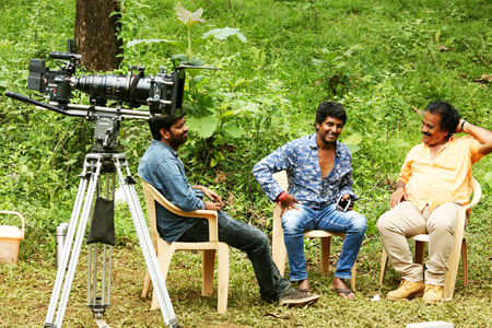 Film director, cinematographer relax on shooting spotのeditorial素材