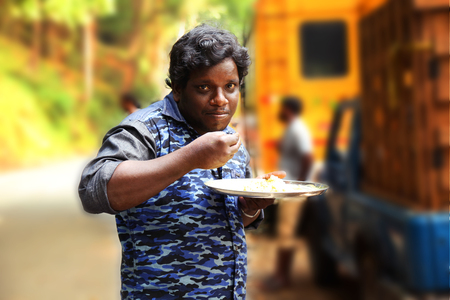 Young man eating food on outdoorのeditorial素材