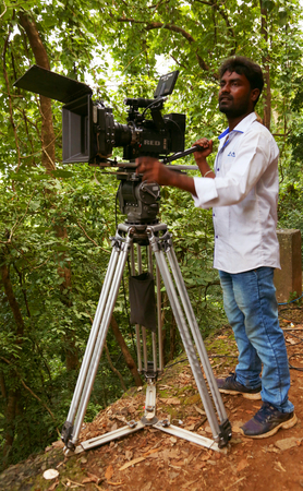 KODAIKANAL, INDIA - JUNE 29TH, 2015: Camera man shooting nature background