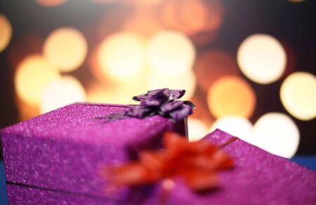Merry Christmas and happy new year with gift box at blur bokeh light backgrounds