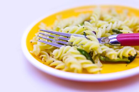plate of pasta with fork on white backgroundsの写真素材