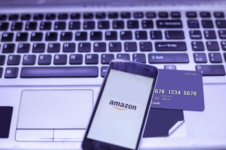 laptop with credit card and smartphone, shopping on Amazon application for online.のeditorial素材