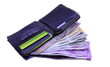 Leather wallet with bank cards and Indian currency note inside on the white table.の写真素材