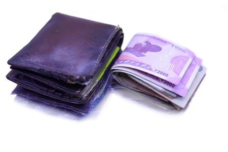 men's purse with money, credit and debit cards on the white tablesの写真素材