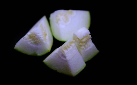 Sliced pumpkin isolated on black backgroundsの写真素材