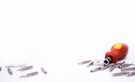 Yellow and red hand screwdrivers and screws isolatedの写真素材