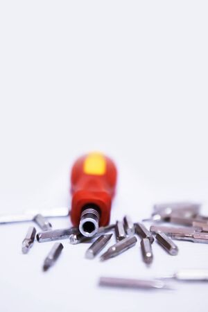 Repair screws to a plastic red and yellow handle and metal screwdriver