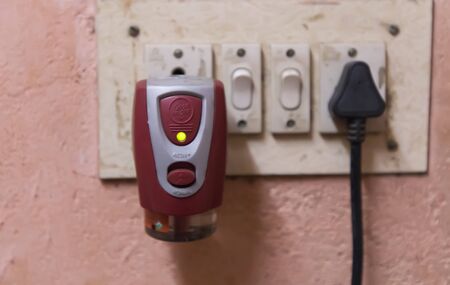 Electric anti mosquito fumigator plugging on the wall socket.のeditorial素材