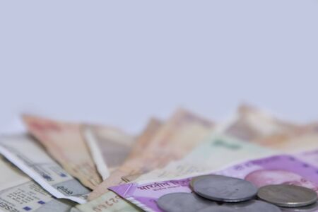 Indian currency bank notes of 500 and 2000 rupees with coins - white background