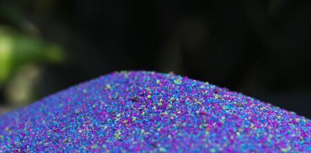 Multi-colored powder on nature background.