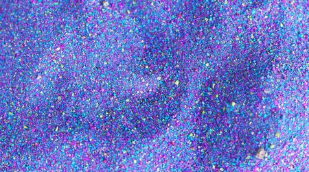 Multi-colored powder sprayed on black background.の写真素材