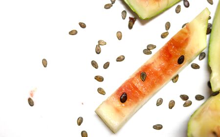 eaten slice of watermelon with watermelon seeds isolated on white backgroundsの写真素材