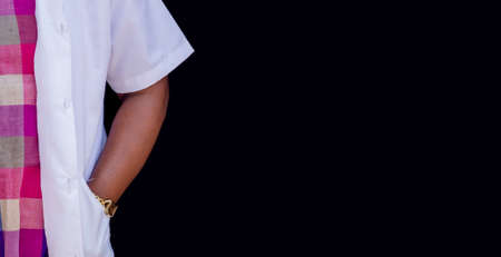 close-up young stylish doctor or nurse in white medical costume is standing with hand in her pocketの写真素材