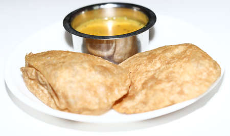 Puri bhaji -An Indian dish consisting of puris and spicy potatoes in white background