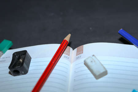 Back to school background with Pencil sharpener, pencil, eraser on top of notebooks.の写真素材