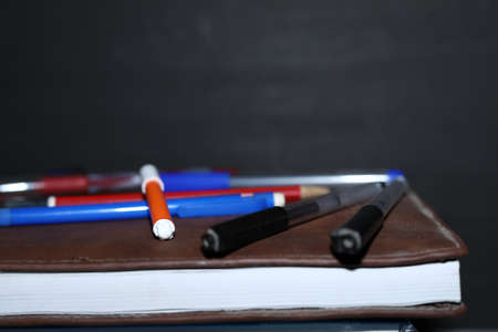 Back to school background with books and pencil and sketch over blackboards