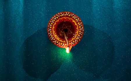 Happy Diwali - Colorful clay diya lamps lit during diwali celebrationsの写真素材