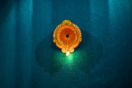 Happy Diwali - Colorful clay diya lamps lit during diwali celebrations
