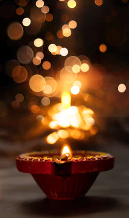 Happy Diwali - Diya lamps lit during diwali celebrationsの写真素材