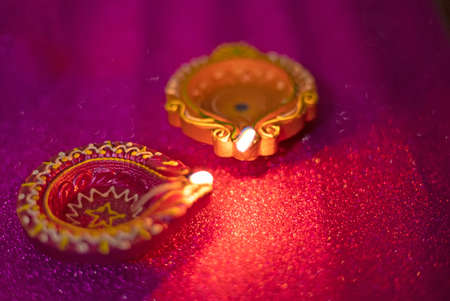 Happy Diwali - Colorful clay diya lamps lit during diwali celebrations