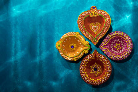 Happy Diwali - Colorful clay diya lamps lit during diwali celebrations