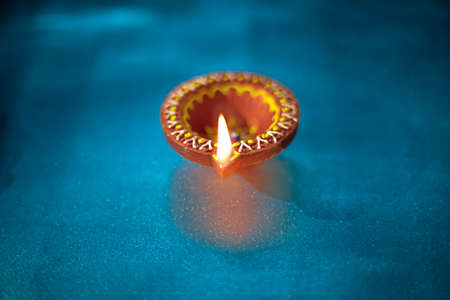 Colorful clay diya lamps lit during diwali celebration
