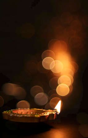 Diwali celebration - Diya lamp with glitter light backgroundsの写真素材