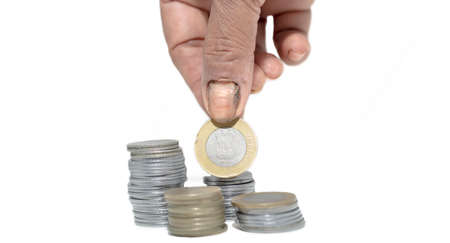 Hand with Indian currency coins isolated on white backgrounds