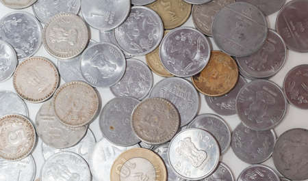 Indian rupee coins scattered on white backgrounds