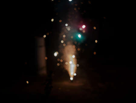 Faint sparks from the fire in front of the black backgrounds