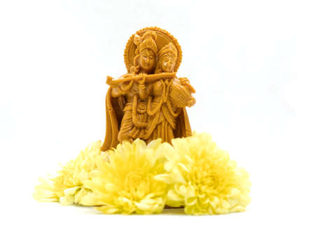 The statue of Radha Krishna with flowers is isolated on a white backgroundsの写真素材