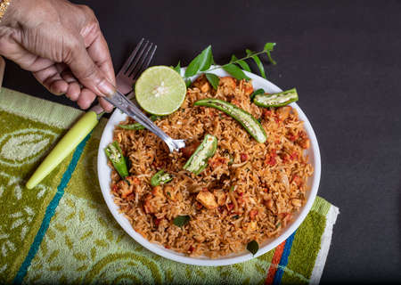 Chicken Rice with lemon and green chillies, curry leaves vegetables top views.
