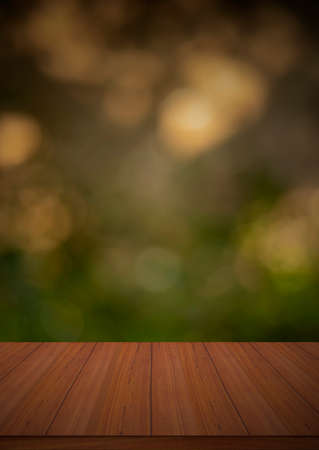 Wood table top against a shiny sunlight bokeh backgrounds - can be used to showcase your productsの写真素材