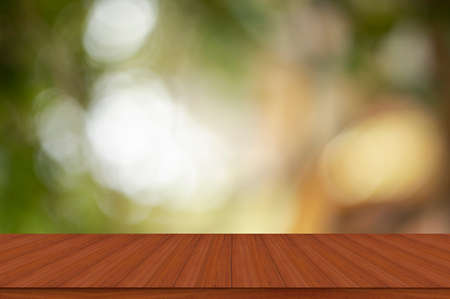 Empty wood table and defocused bokeh and blur backgrounds with sunlight. product display template.
