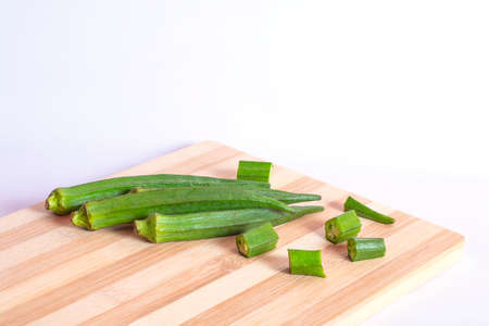 Green fresh ladies finger or Okra Vegetable on the cutting board isolated on the white backgrounds