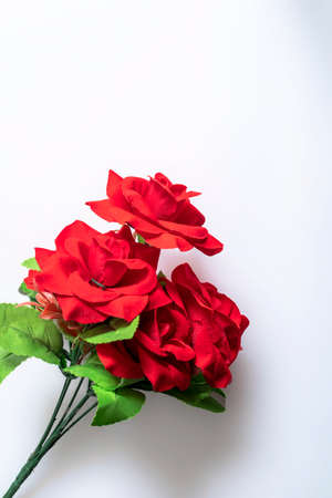 Bouquet of red plastic roses on a white background. copy spaceの写真素材