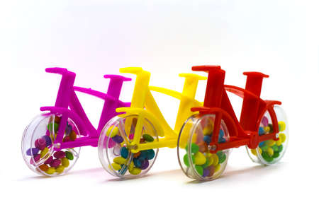 Plastic toy bicycle with chocolate nut candy inside the bicycle wheel.