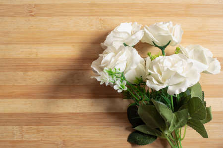 A white roses on a wooden table.の写真素材